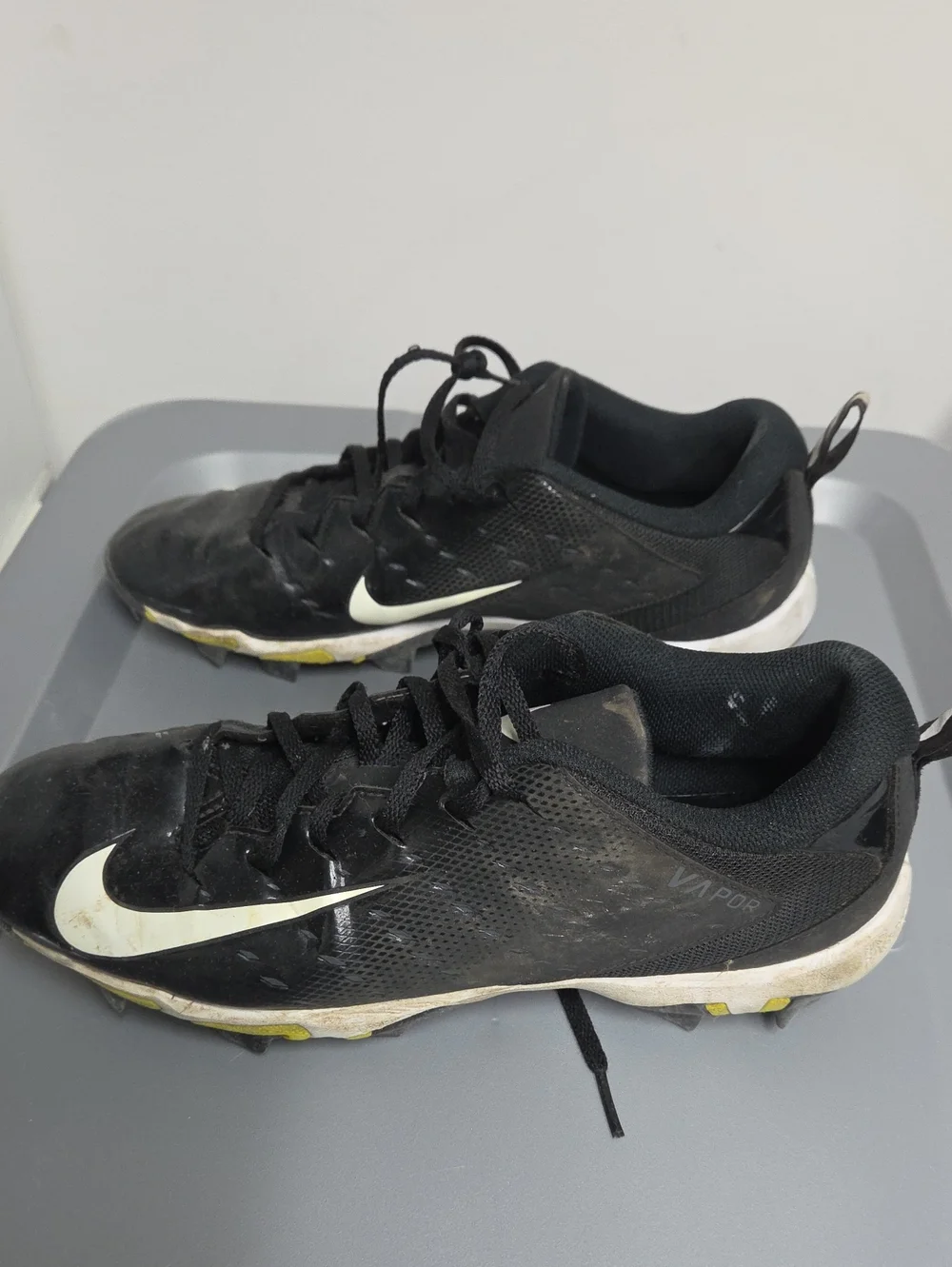 Nike Black and White Youth Athletic Cleats with Yellow Studs